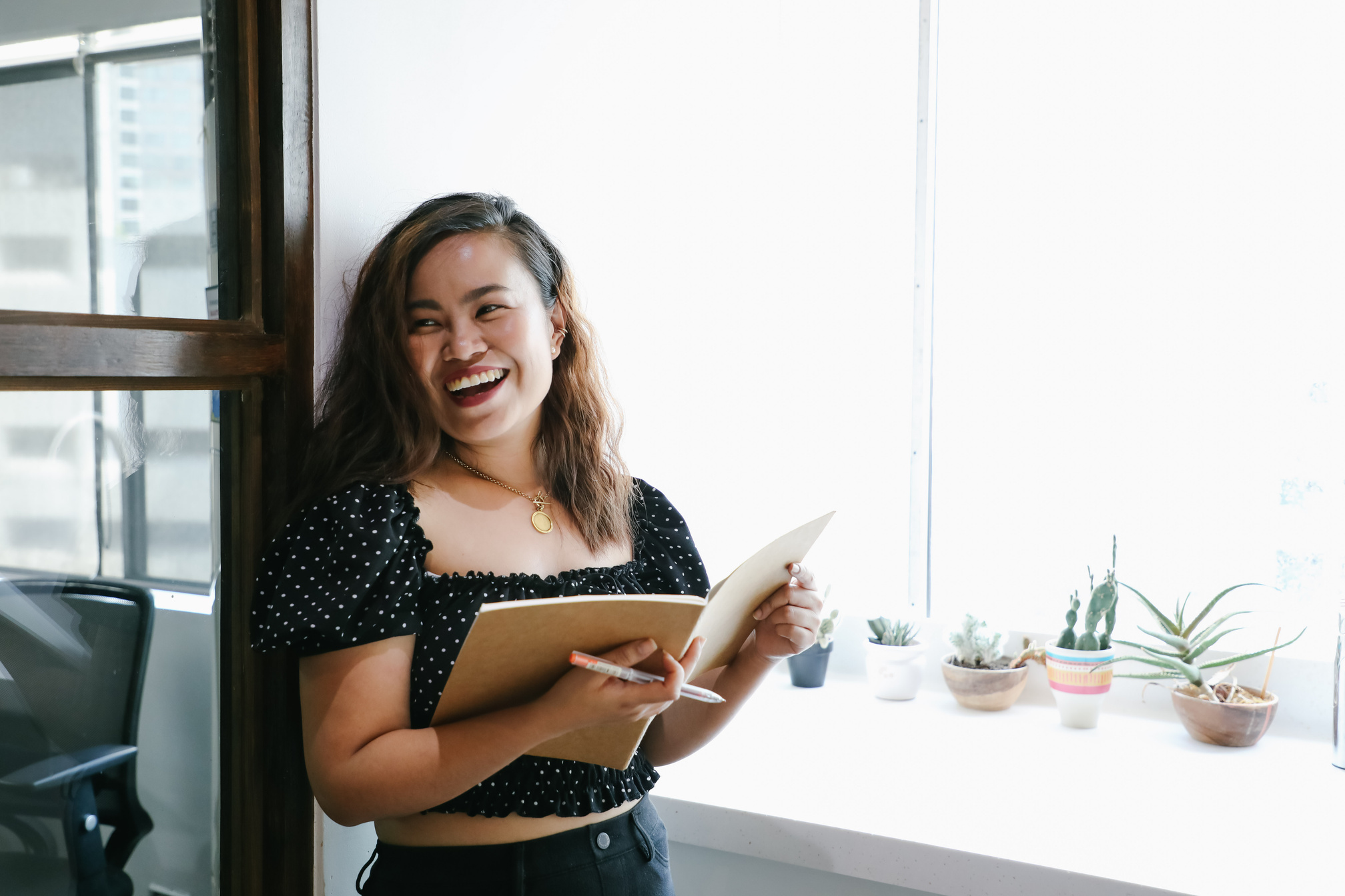 Woman with notebook and pen in the office